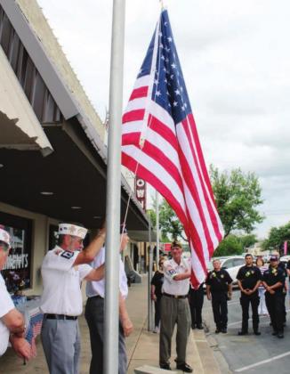 Two Main Street flag poles are now adorned with an American flag and a Texas flag due to a cooperative effort between a business owner and the Marble Falls VFW Post 10376. Pictured, from left, are Wesley Lewis, Post Commander Lloyd Crippen and RV Turney.