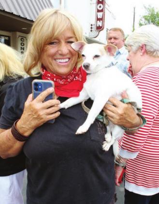 Burnet County resident Sid Holden attended the Main Street flag re-installation ceremony on June 1 in Marble Falls with a cute four-legged friend.