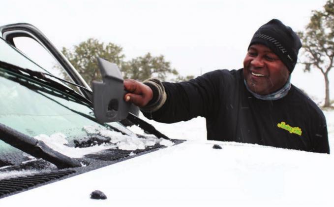 Freddie Walker of Granite Shoals stopped at the roadside park on US 281 just north of Marble Falls to remove ice accumulations on his windshield. He was also delayed by a multiple vehicle collision farther north which snarled traffic for more than an hour. Photos by Connie Swinney/The Highlander