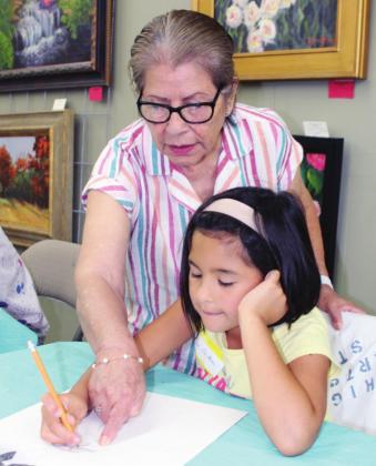 Artist and volunteer Ludo DeChene assisted her granddaughter Emi DeChene with a sketch art piece June 14 at Highland Arts Guild for the venue’s week-long camp. Photos by Connie Swinney/The Highlander 