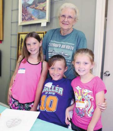 Highland Arts Guild in Marble Falls is hosting a week-long program for youngster June 14-18 at the venue, 318 Main St. Among participants of the week-long camp are, from left, Addie Martin and her grandmother Pat Laird of Horseshoe Bay as well as Addie’s cousins Emma Martin and Sky Laird, both of Horseshoe Bay. 
