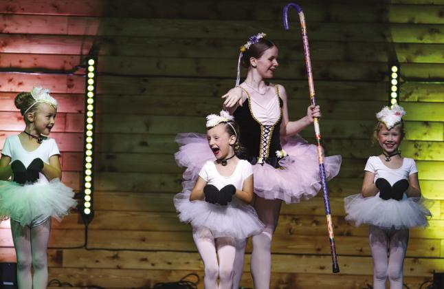 Soloist Sarena Wathen tapped the heads of the baa-ing sheep Zoe Hager, Reagan Miller and Heidi Meredith during 'Gifts of Christmas,' a production Dec. 8 of the Harmony School of Creative Arts.