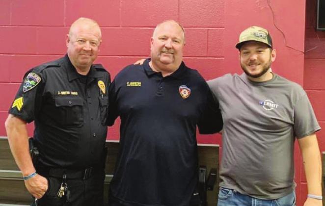 The Granite Shoals Police Officers Association announced a significant donation was made to Coy Guenter (center) of the Marble Falls Fire Department as his continues his battle with cancer. This donation was made possible by the sale of barbecue briskets cooked and coordinated with GSPD Sgt. John Ortis (left) and Officer Allen Miley. Contributed/GSPD