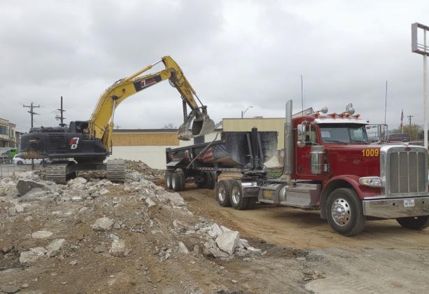 Demolition crews were busy March 6 clearing the lot where the Mayfield Building in Marble Falls downtown business area stood before a fire burned the structure to the ground last Oct. 4. Beverly Walker/The Highlander