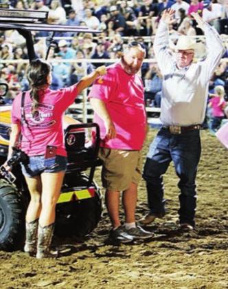 Lynette Courtney, left, and Steve Rogers surprise Capt. Coy Guenter with the news he was receiving money raised at Friday’s steer saddle competition at the Marble Falls Rodeo. Kelly McDuffie/ Special to The Highlander