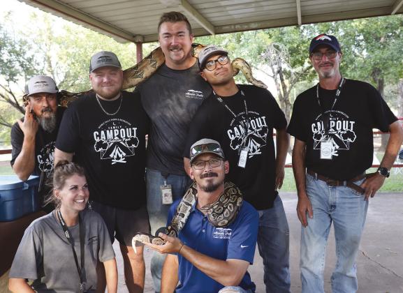 City of Marble Falls Parks and Recreation crew members make the most of the Reptile Show on Oct. 15 at the Family Campout at Johnson Park in Marble Falls. They got up close and personal with a Boa constrictor and a ball python.