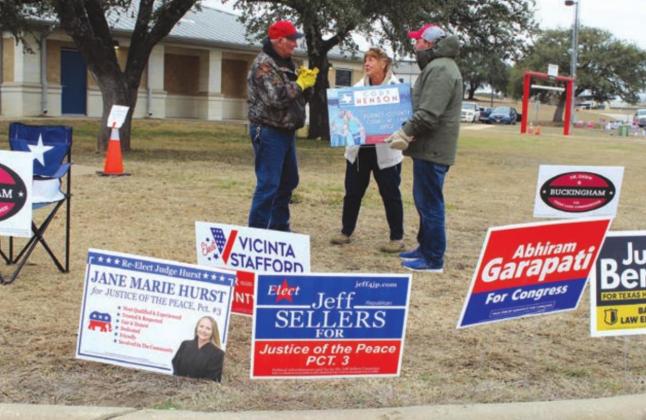 (From left) Meadowlakes resident Gerry Mason and Marble Falls resident Cherie Miller stopped to chat with GOP court-at-law primary candidate Cody Henson as he stumped near the curb of the Marble Falls courthouse annex on the final day of early voting. Connie Swinney/The Highlander