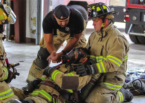 Marble Falls firefighters Capt. Jeff Beltran and Bobby Amick (right), both of Marble Falls Fire Rescue, participated in No Quit RIT fire training in Burnet last week. Crouching (left) is MV Fire Instructor Josh Lantz. See more photos on Page 6B. Contributed/ Alamo Area Fire Photography