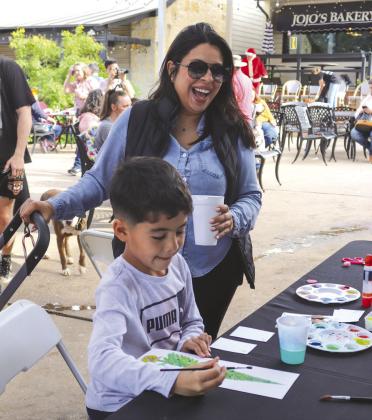 Luke Sanchez with mom Elisa Sanchez enjoyed the children's activities during the Christmas Market on Main Dec. 2 in Marble Falls.