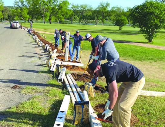 LCRA employees installed a fence at the Llano River Golf Course in Llano during LCRA's Steps Forward Day on April 12.